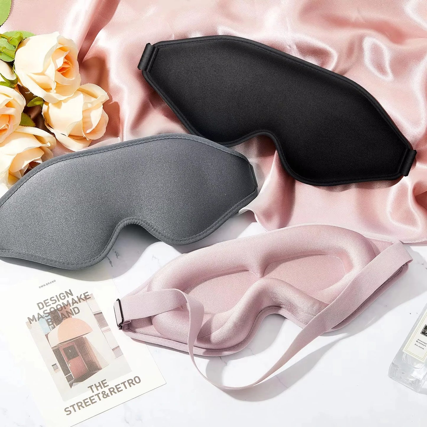 Two sleep masks, one black and one grey.