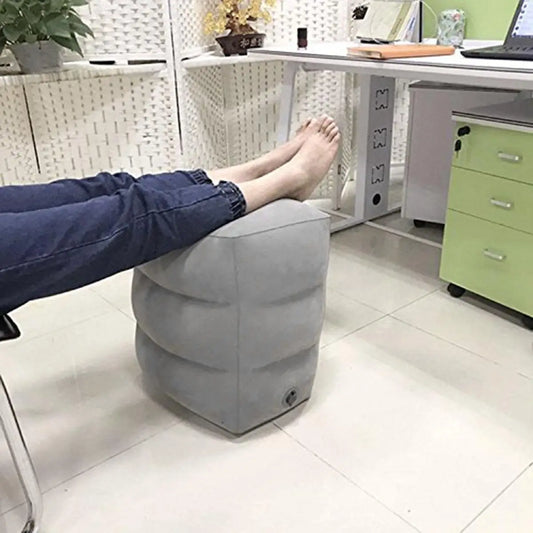 Person using a footrest in an office setting.
