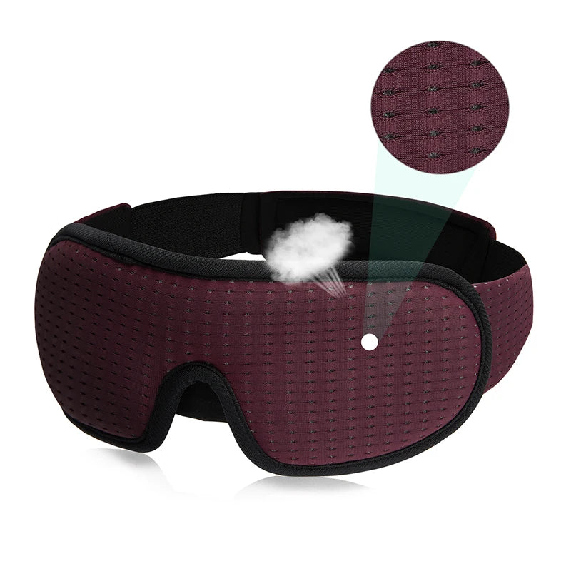 Maroon sleeping eye mask with black straps.