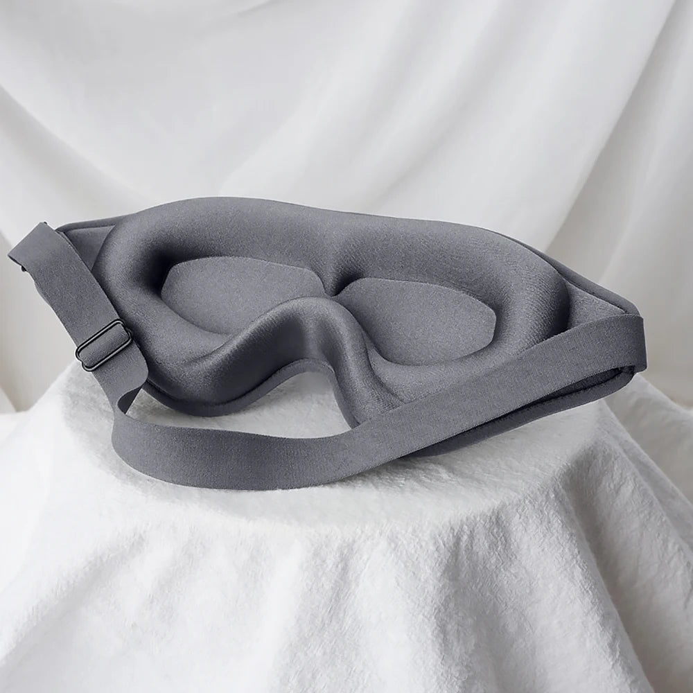 Gray sleep mask on a white fabric background