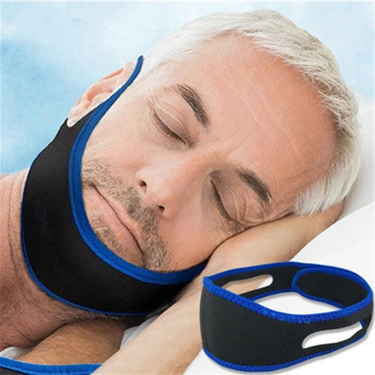 Man sleeping with a blue and black anti snoring chin strap.