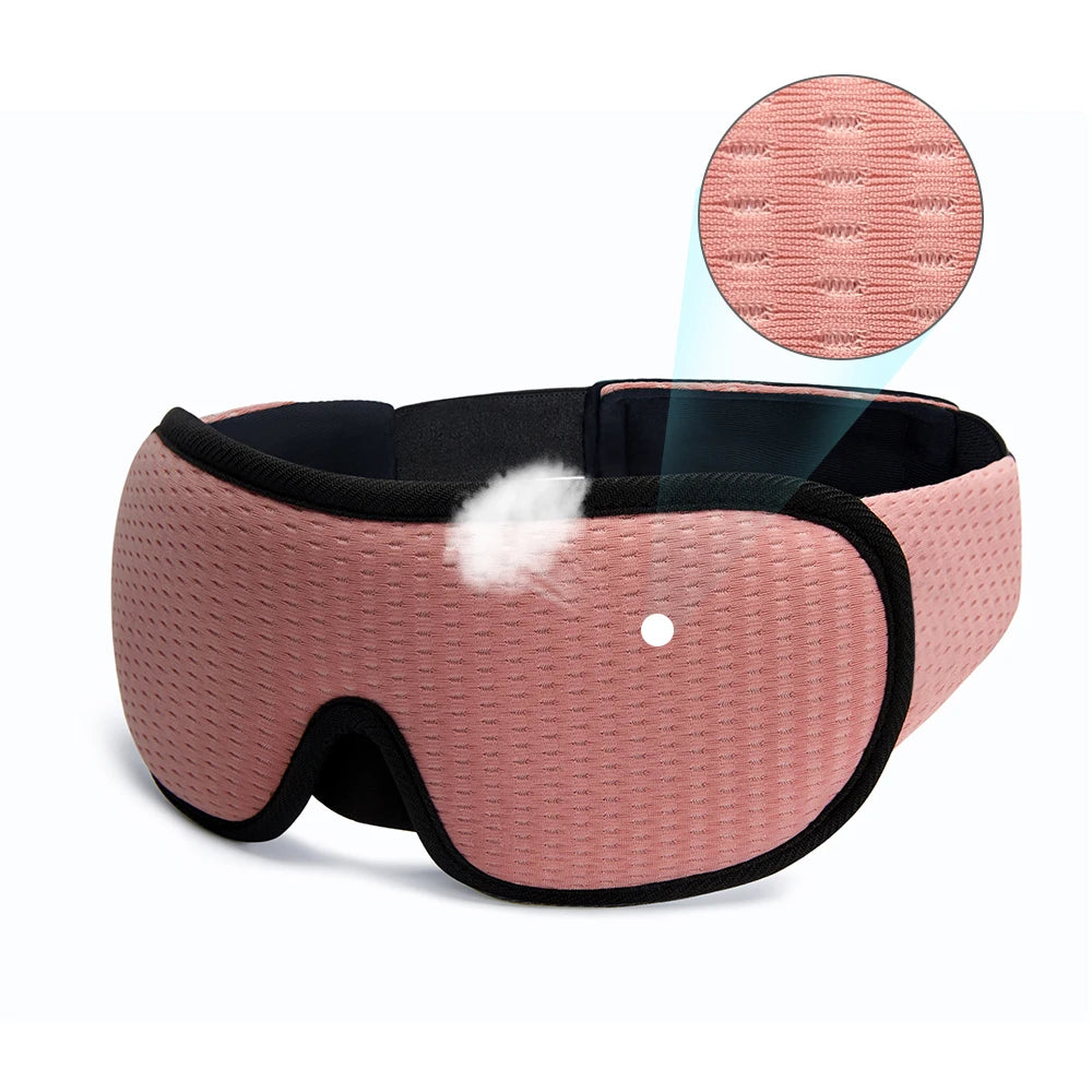 Pink sleeping eye mask with black straps.
