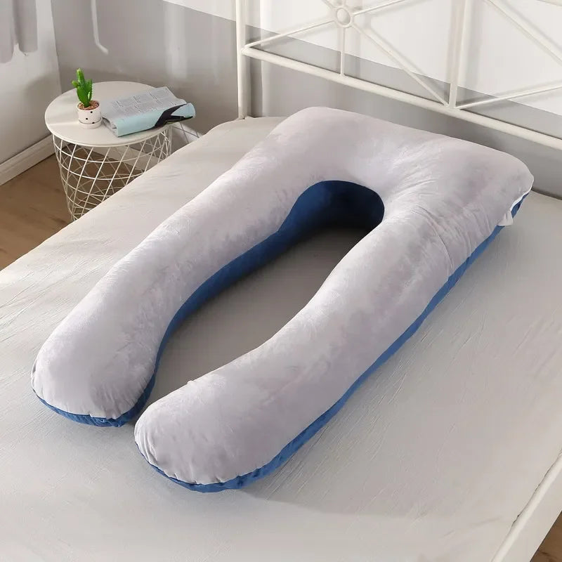 Light grey U-shaped body pillow in a bedroom.