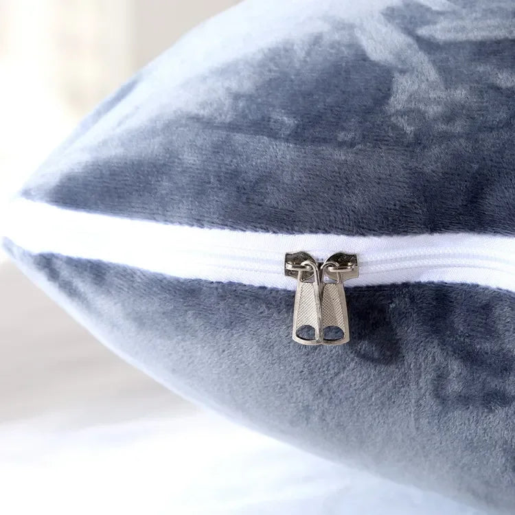 Close up view of the zip on the grey U-shaped pillow.
