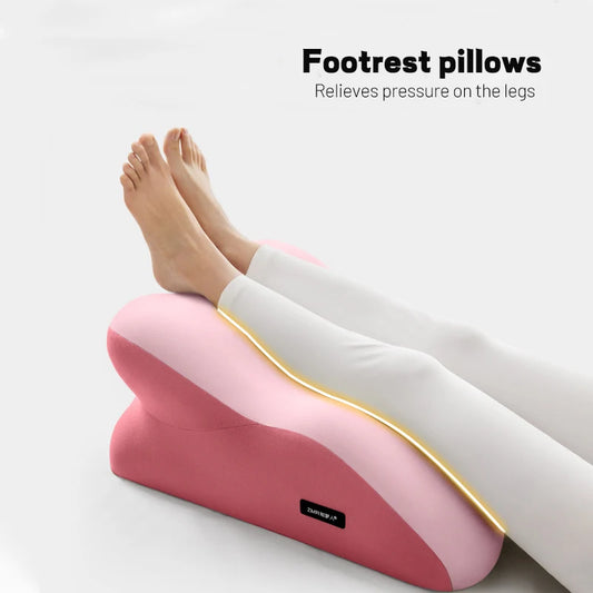 Pink footrest pillow with legs resting on it, against a white background