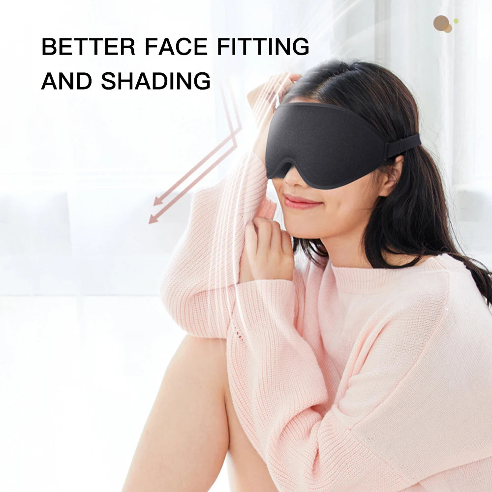 Woman wearing a comfortable black sleep mask that fits her face and blocks 100% of the light.