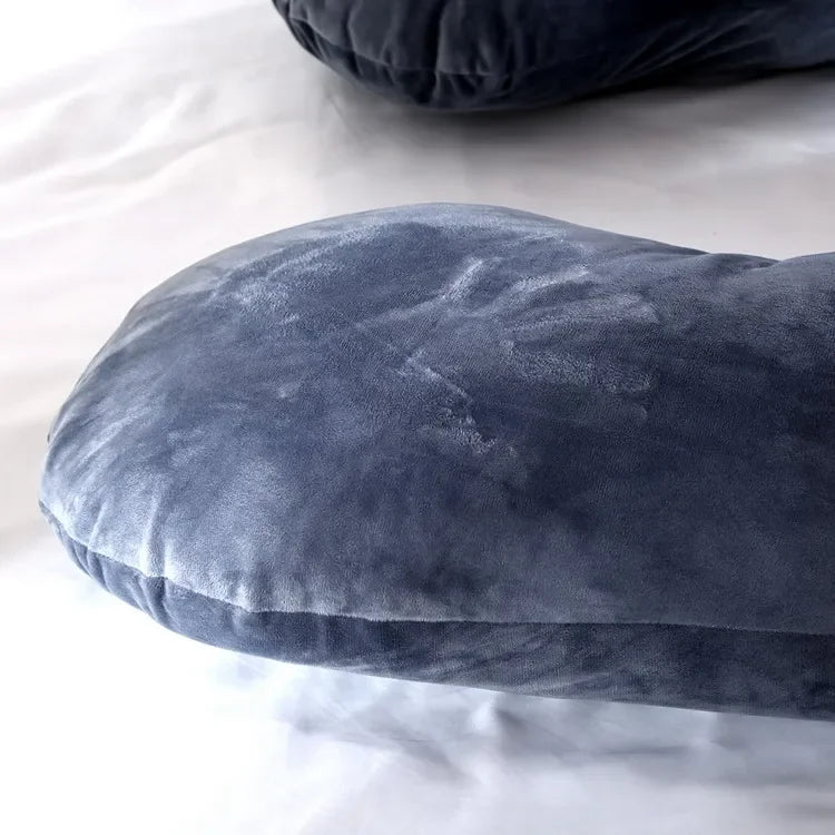 Close up view of the grey U-shaped body pillow.