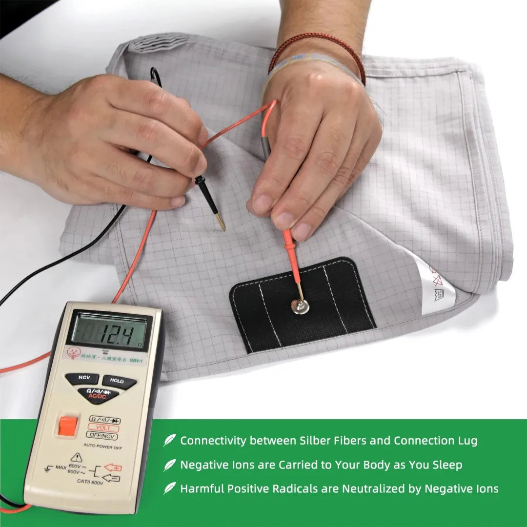 Person testing the grounding Sleep Well earthing fabric with a device, showing connectivity and negative ion benefits.