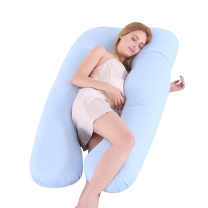 Pregnant woman lying on a blue U-shaped pillow. 