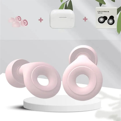 Pink wireless earbuds with a white charging case on a light gray background