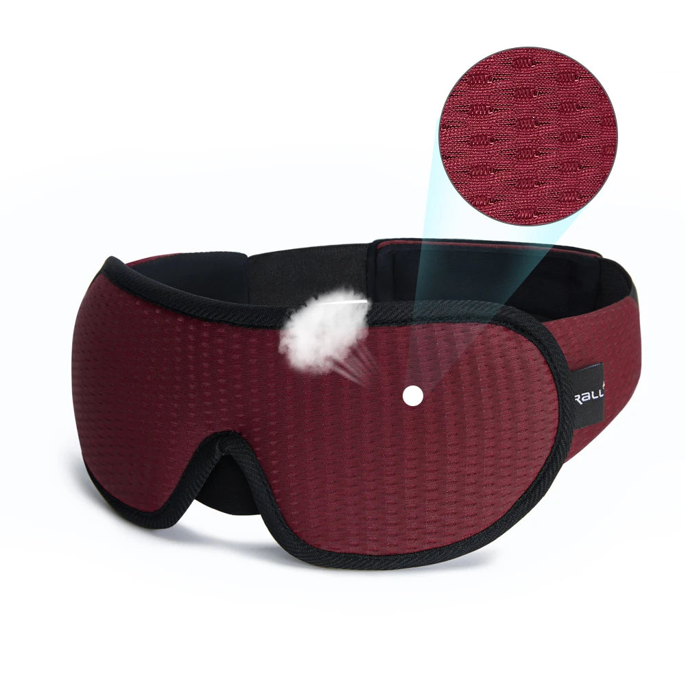 Red sleeping eye mask with black straps.