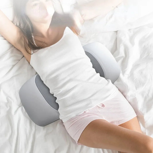 Person using a lumbar support pillow while sleeping.