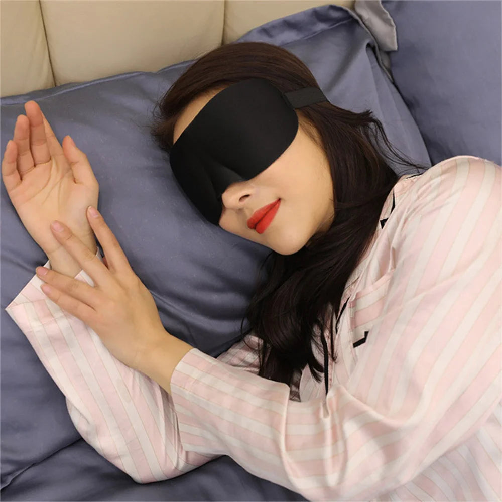 Sleeping woman wearing a black sleep mask comfortably.