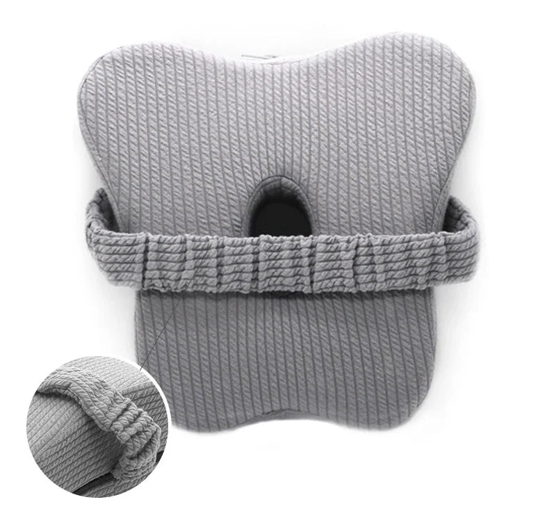 Close up view of the light grey leg pillow. 