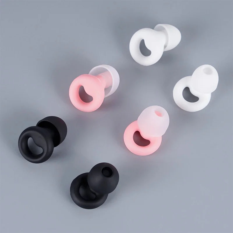 Black, pink, and white silicone earbuds.