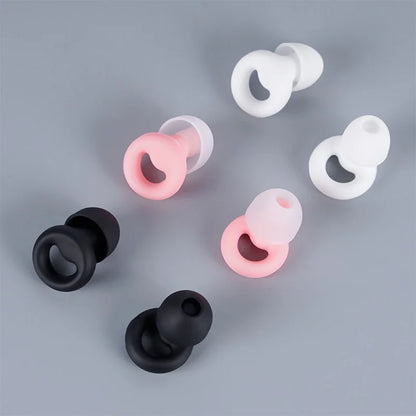 Black, pink, and white silicone earbuds.
