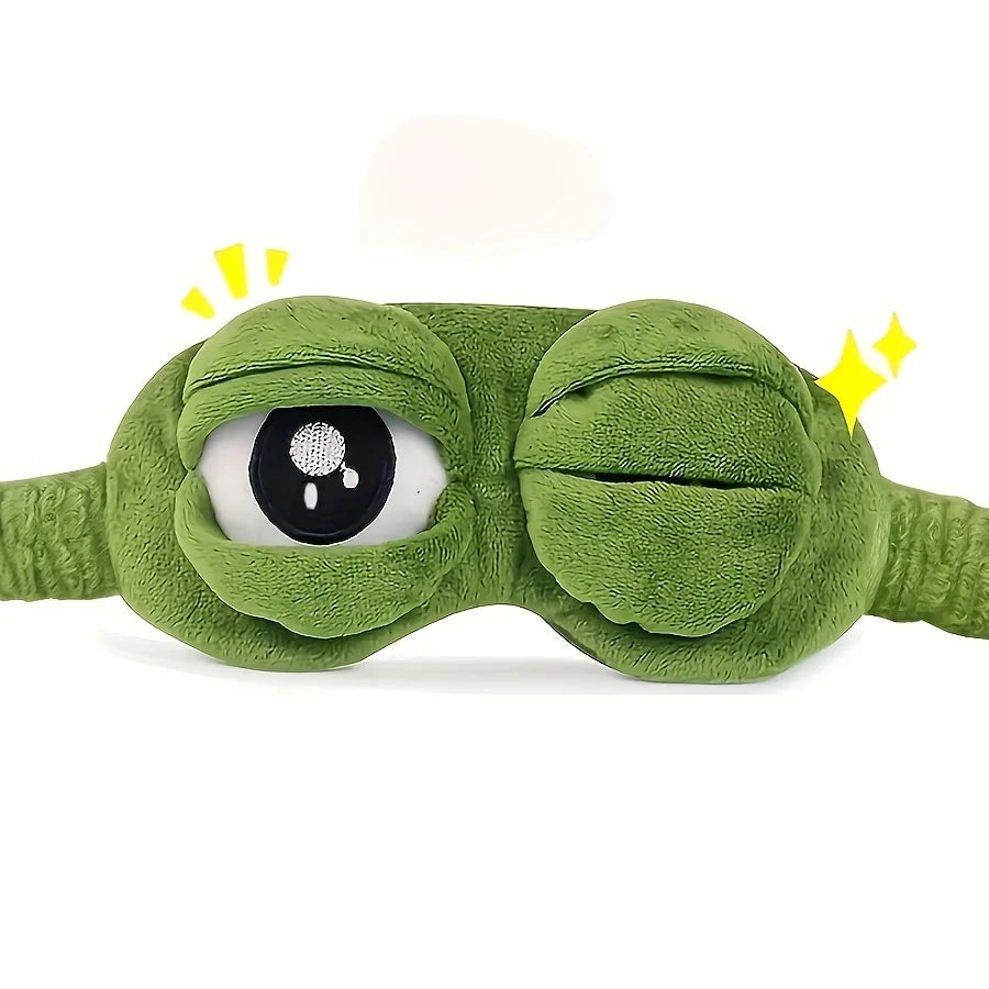 Green frog-shaped eye mask, left eye open.