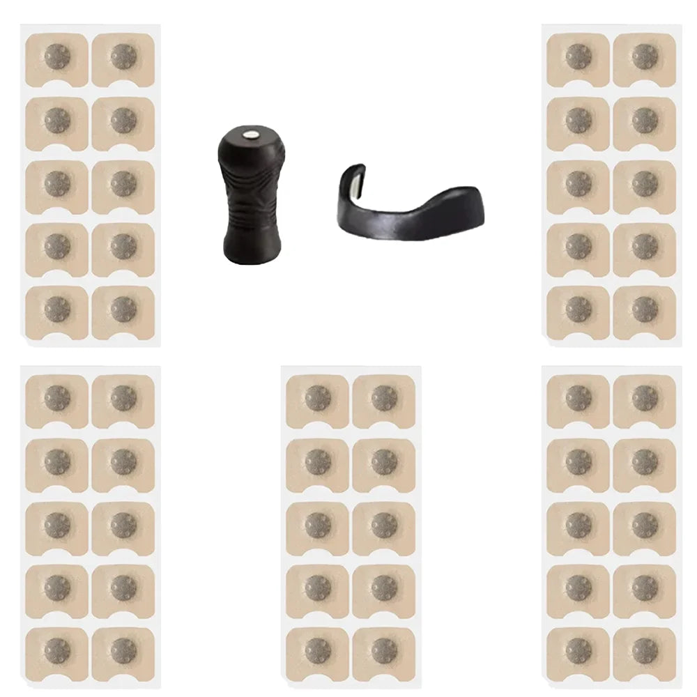 Collection of adhesive patches and black clips on a white background