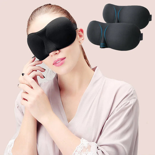 Woman wearing a black sleeping eye mask that blocks out 100% light.