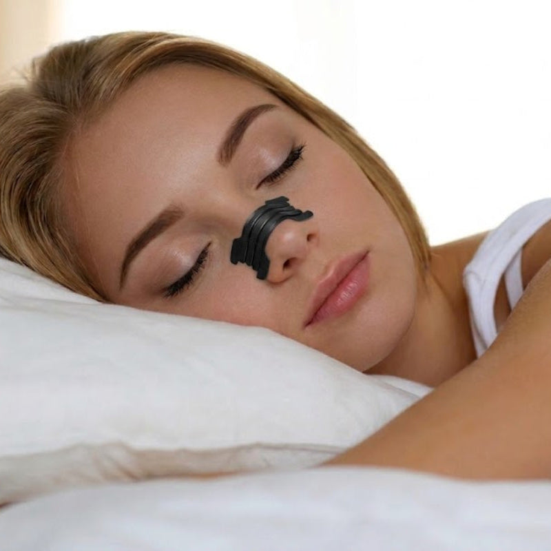 Woman sleeping with black nose strip