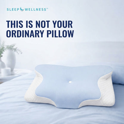 A light blue and white contoured pillow displayed on a bed with the text 'THIS IS NOT YOUR ORDINARY PILLOW' and the brand 'SLEEP WELLNESS' at the top.