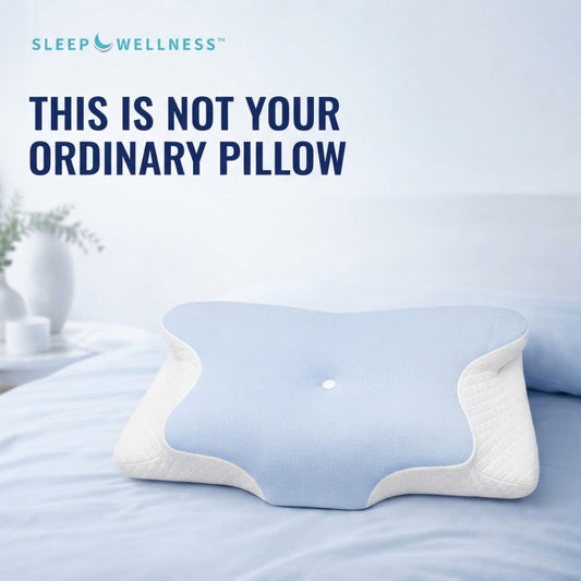 A light blue and white contoured pillow displayed on a bed with the text 'THIS IS NOT YOUR ORDINARY PILLOW' and the brand 'SLEEP WELLNESS' at the top.